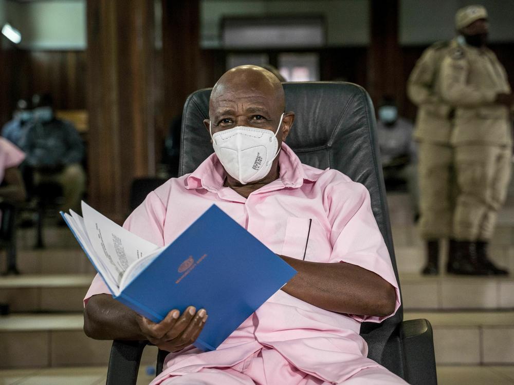 Paul Rusesabagina looks on as he sits with some of his co-accused at the Supreme Court in Kigali, Rwanda, on Feb. 17, 2021, where he denied charges of being associated with an armed group. On Friday, the Rwandan government said it commuted his sentence.