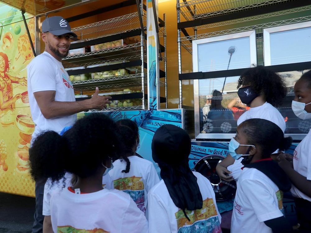 In this 2021 file photo, NBA star Steph Curry talks to kids in Oakland, Calif., about nutrition and exercise.