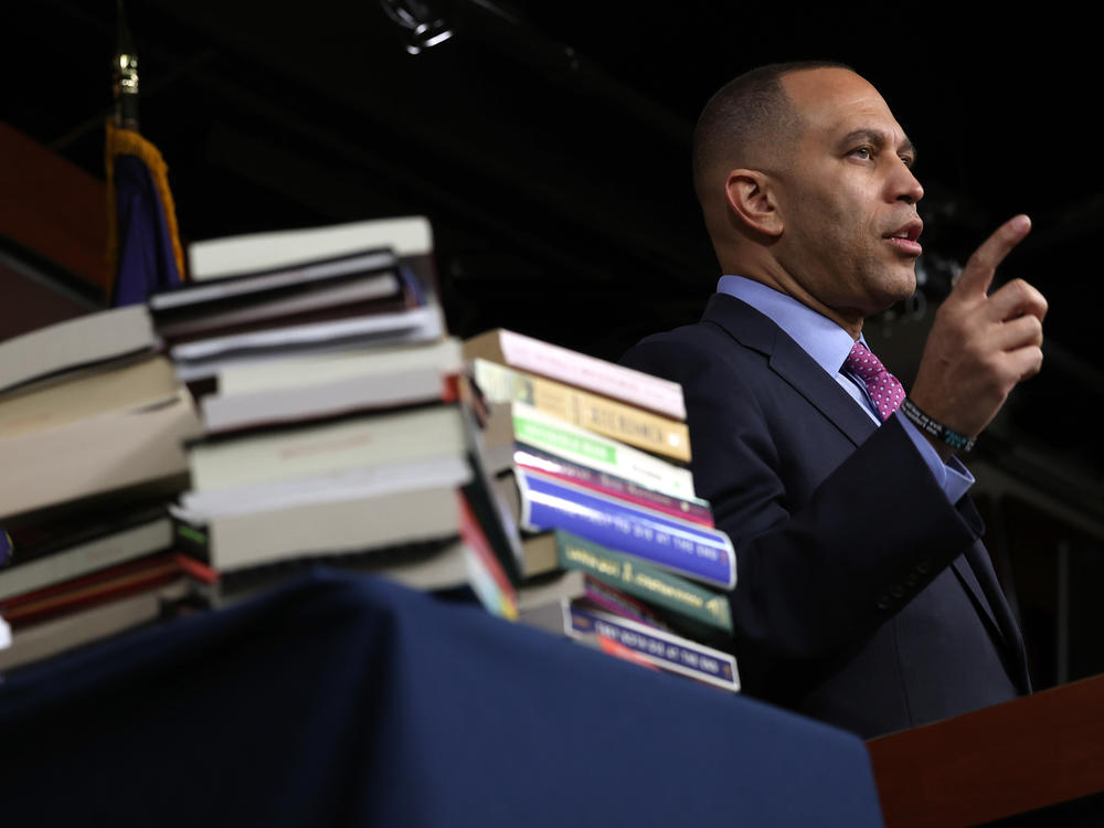 House Minority Leader Hakeem Jeffries speaks alongside a stack of banned books during a press conference on March 24.