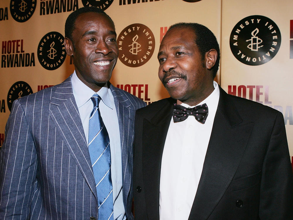 Actor Don Cheadle (left) and real-life inspiration for the film <em>Hotel Rwanda</em>, Paul Rusesabagina, attend the movie's premiere on Dec. 2, 2004, in Los Angeles.