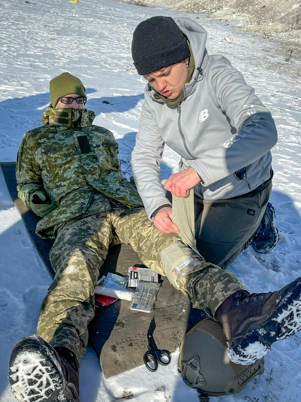 Shannon Taylor, 25, a trauma nurse from New Zealand, teaches a Ukrainian conscript battlefield first aid. Soldiers have told her what she has taught them has helped them save lives.