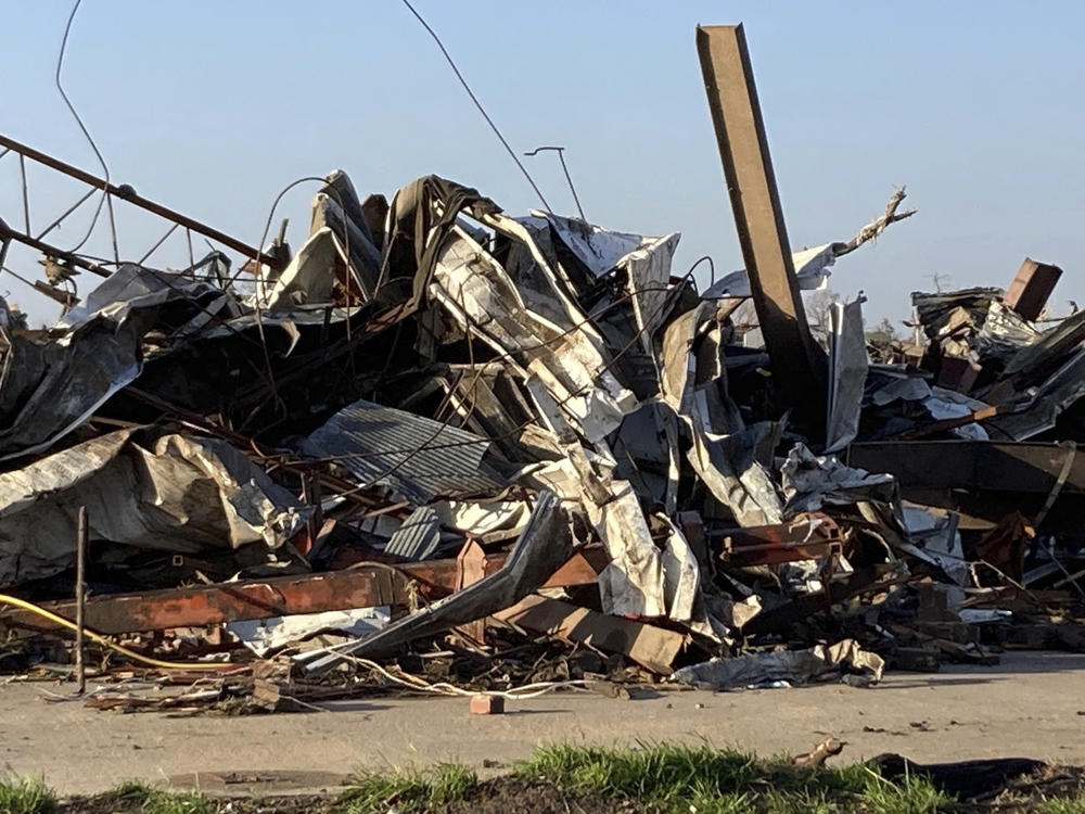 Debris covers a damaged structure in Rolling Fork, Miss,. on Saturday. A powerful tornado tore through the Deep South on Friday night, killing several people in Mississippi and obliterating dozens of buildings.