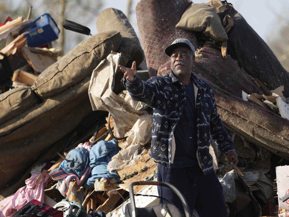 A resident looks through piles of debris, insulation and home furnishings to see if anything is salvageable at a mobile home park in Rolling Fork, Miss., on Saturday.