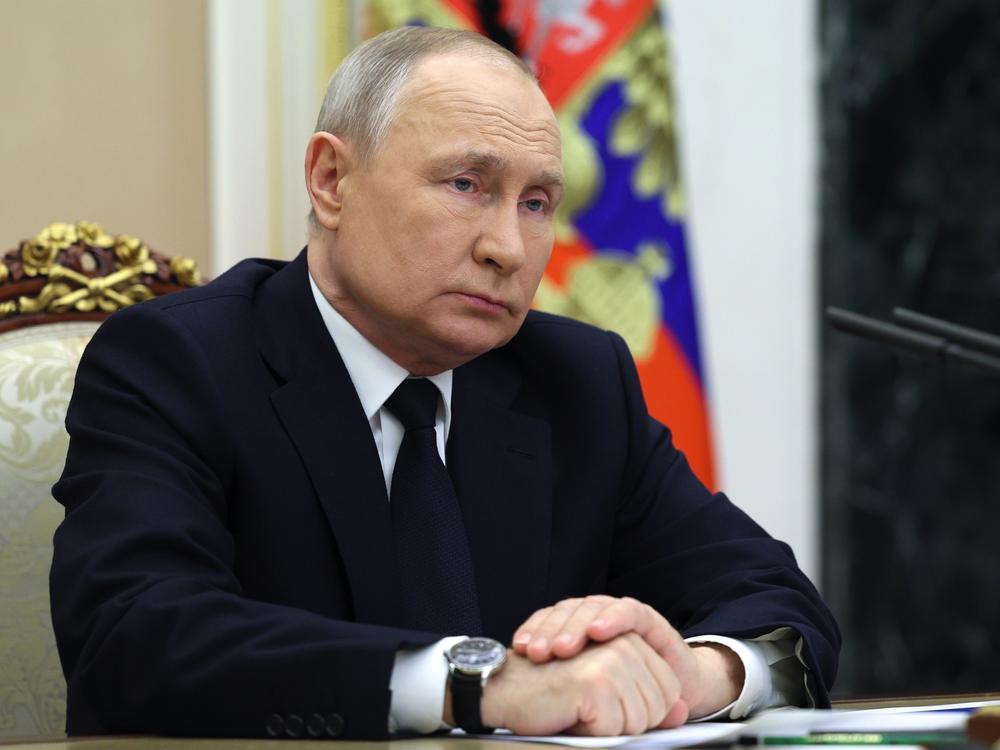 Russian President Vladimir Putin listens to Russian Transport Minister Vitaly Savelyev during a meeting in Moscow on Saturday.