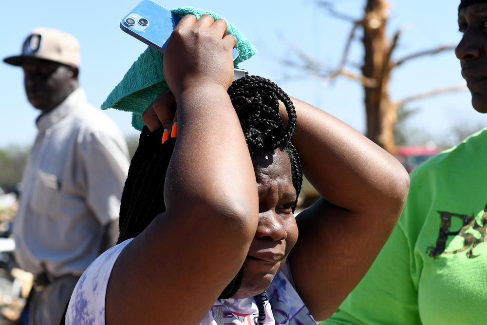 Kenterica Sardin, 23, becomes emotional after assessing damage to her home.