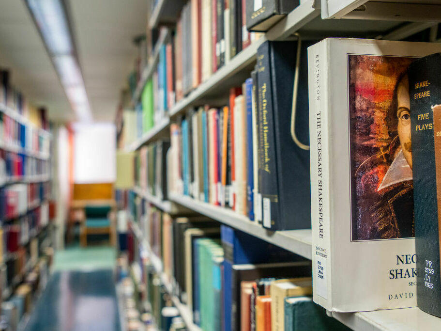 Books line the shelves at the Rice University Library in April 2022 in Houston.