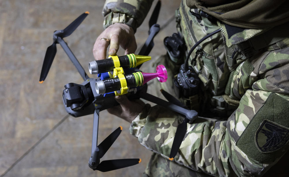 A Ukrainian soldier attaches grenades to a DJI Mavic 3 drone on Feb. 18 in Bakhmut, Ukraine. Ukrainian forces have acquired large numbers of  commercial drones made by China's DJI and modified them to carry grenades and other small explosives.