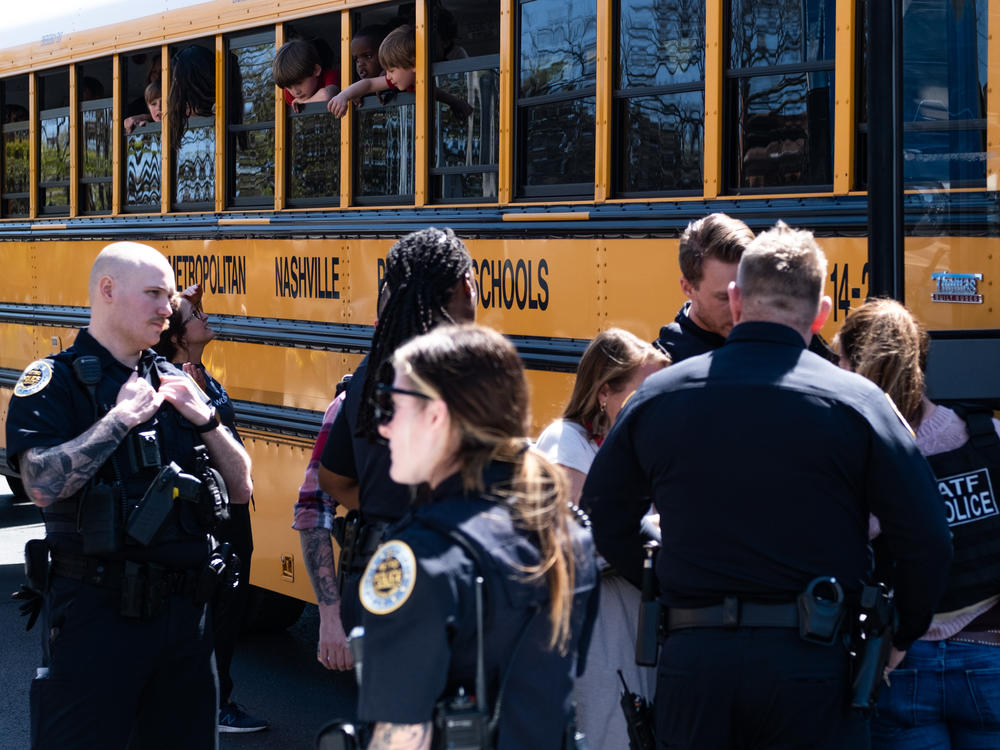 School buses with children arrive at Woodmont Baptist Church to be reunited with their families after a mass shooting at The Covenant School on Monday in Nashville.