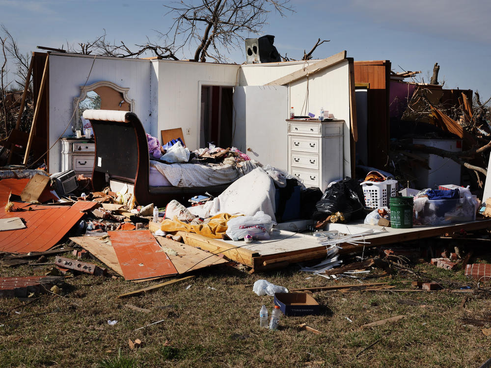 Most walls are gone but furniture remains intact where a home once stood in Rolling Fork, Mississippi.