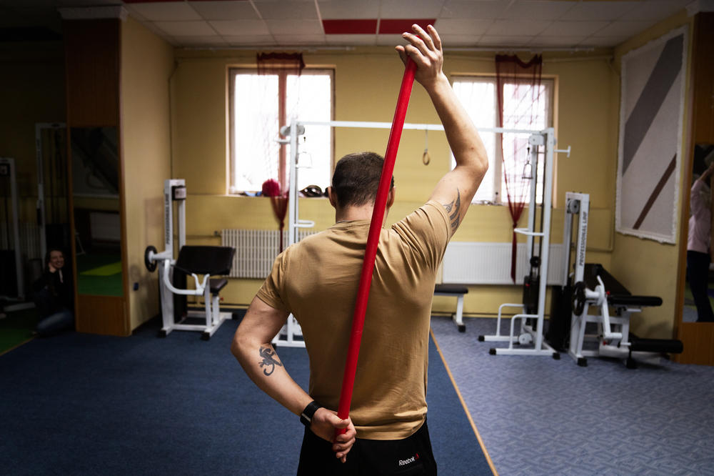 One soldier works on back strengthening exercises during a fitness class.