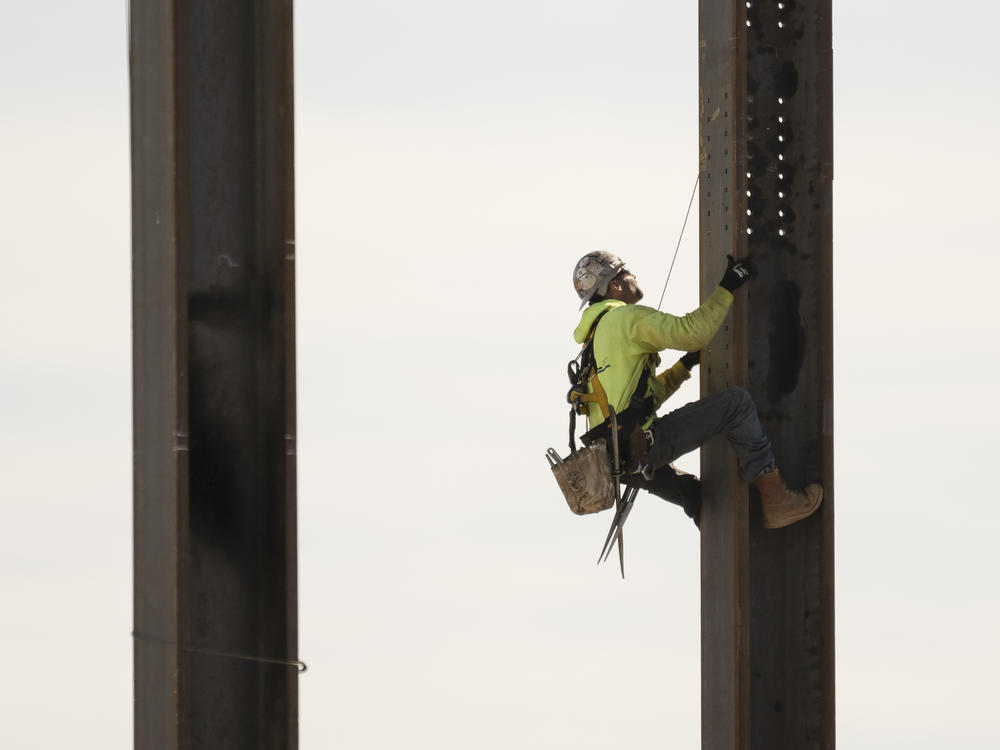 An ironworker scales a column during construction of a municipal building in Norristown, Pa. on Feb. 15, 2023.