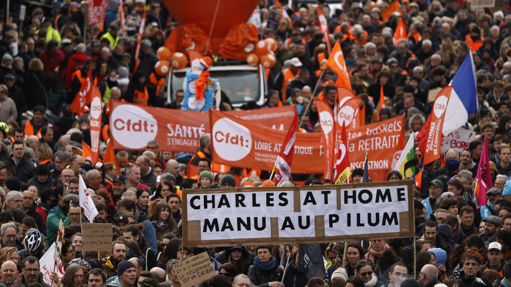 Workers demonstrate with a poster referring the King Charles III's canceled visit, on Tuesday in Nantes, western France.
