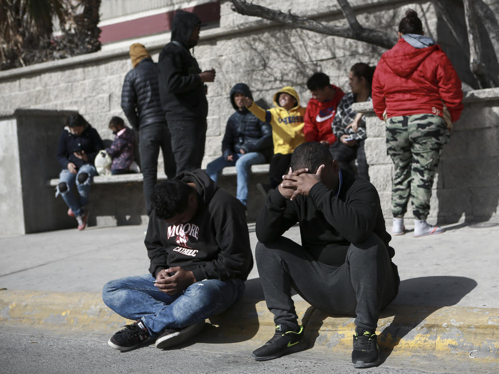 Migrants grieve in front at a Mexican immigration detention center in Ciudad Juarez, Mexico on Tuesday.