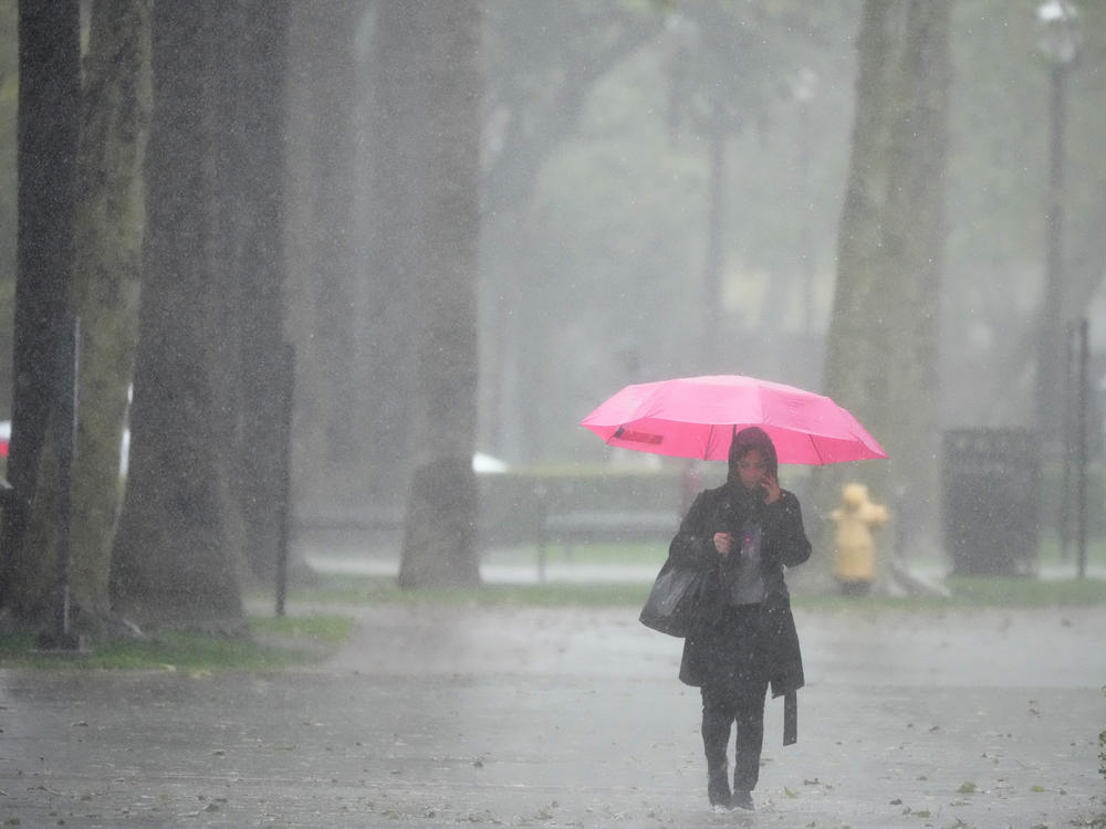 Rain falls on a pedestrian on the University of Southern California campus on Tuesday, March 21, 2023, in Los Angeles.