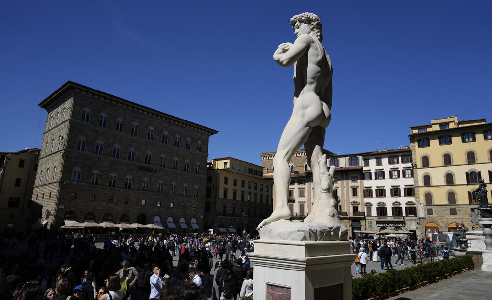 Visitors gather near a copy of the marble statue of Michelangelo's David in Piazza Della Signoria square in Florence, Italy, on Tuesday.