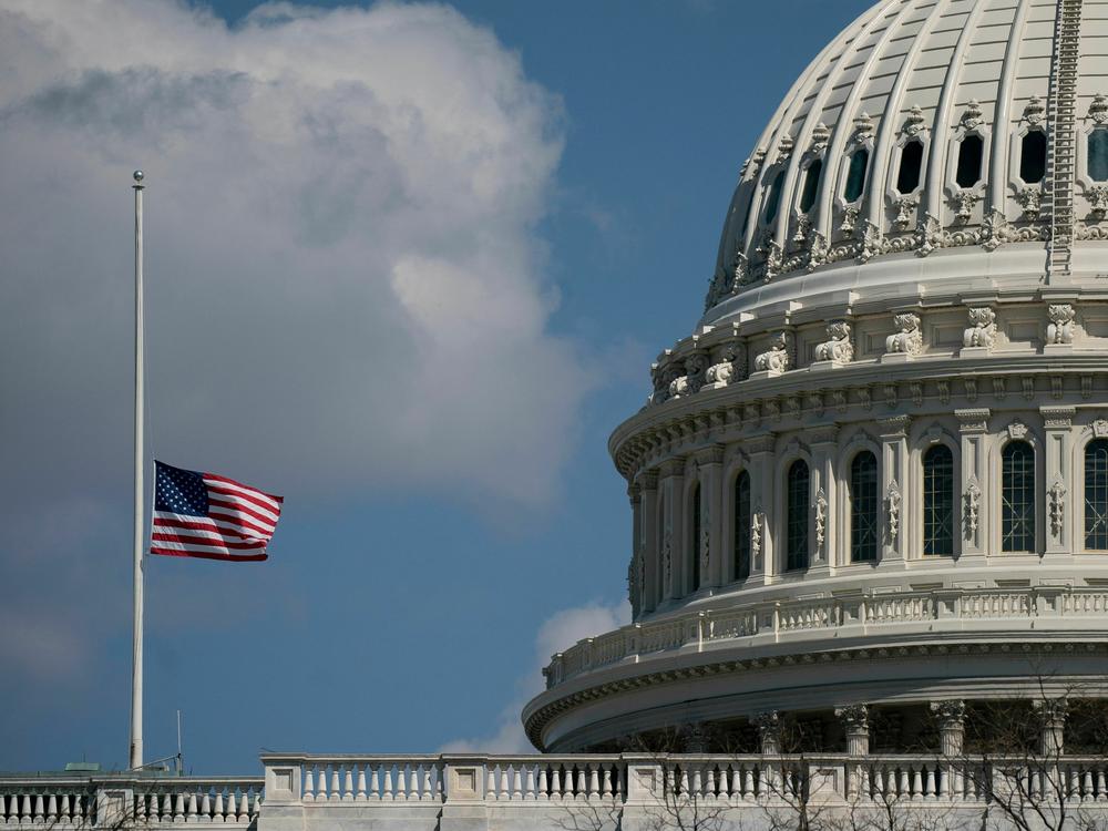 The U.S. flag flies at half-staff outside the U.S. Capitol on Wednesday.