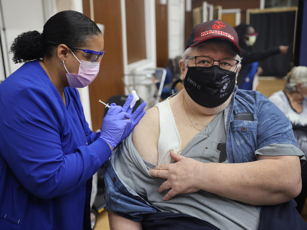 Shana Alesi administers a COVID-19 booster vaccine to Marine Corps veteran Bill Fatz at the Edward Hines Jr. VA Hospital in Hines, Ill., in 2021. A new round of boosters could become available for some people this spring.