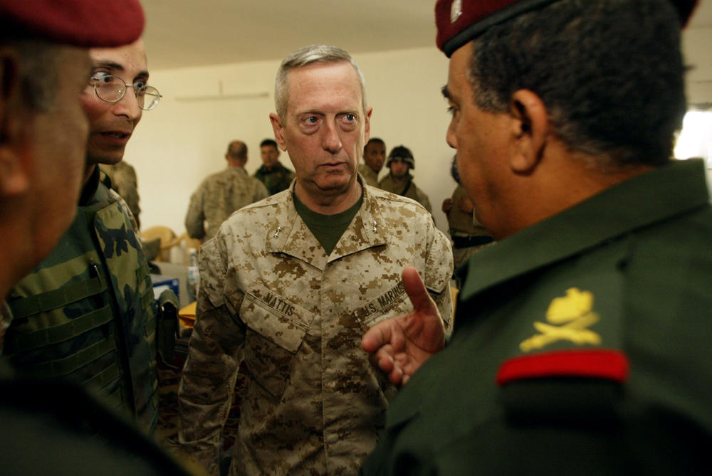 U.S. Marine Maj. Gen. James Mattis (center) talks with Iraqi Maj. Gen. Jassim Mohammed Saleh (right) during discussions held about the transfer of authority to the newly formed Fallujah Protective Army on May 2, 2004.