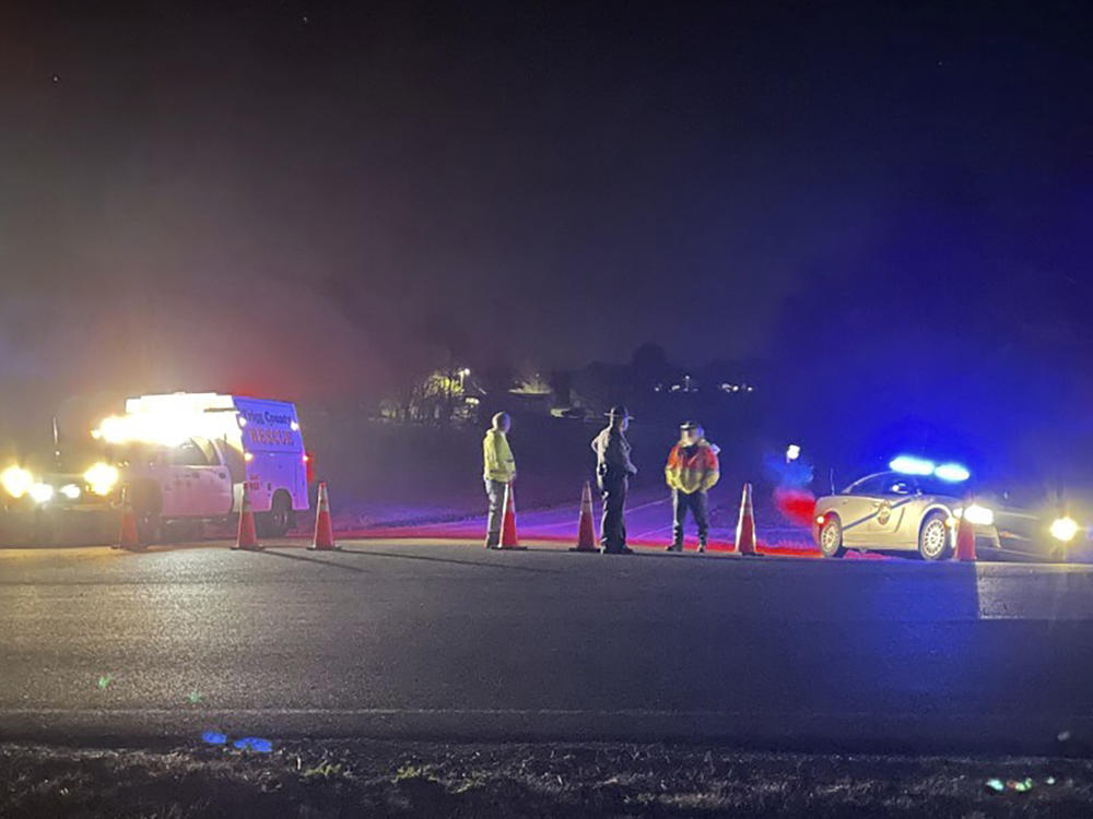 Emergency responders are seen near a site where two military helicopters crashed Wednesday night during a routine training mission in Trigg County, in southwestern Kentucky, on March 30, 2023.