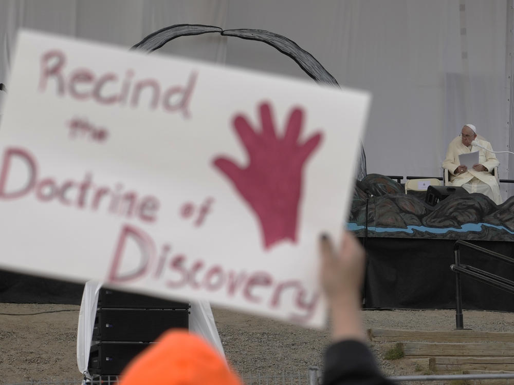 People protest as Pope Francis meets young people and elders at Nakasuk Elementary School Square in Iqaluit, Canada, last July. The Vatican on Thursday formally repudiated the 