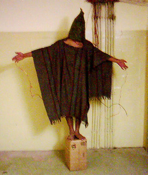 An image obtained by The Associated Press shows an unidentified detainee standing on a box with a bag on his head and wires attached to him in late 2003 at the Abu Ghraib prison in Baghdad, Iraq.
