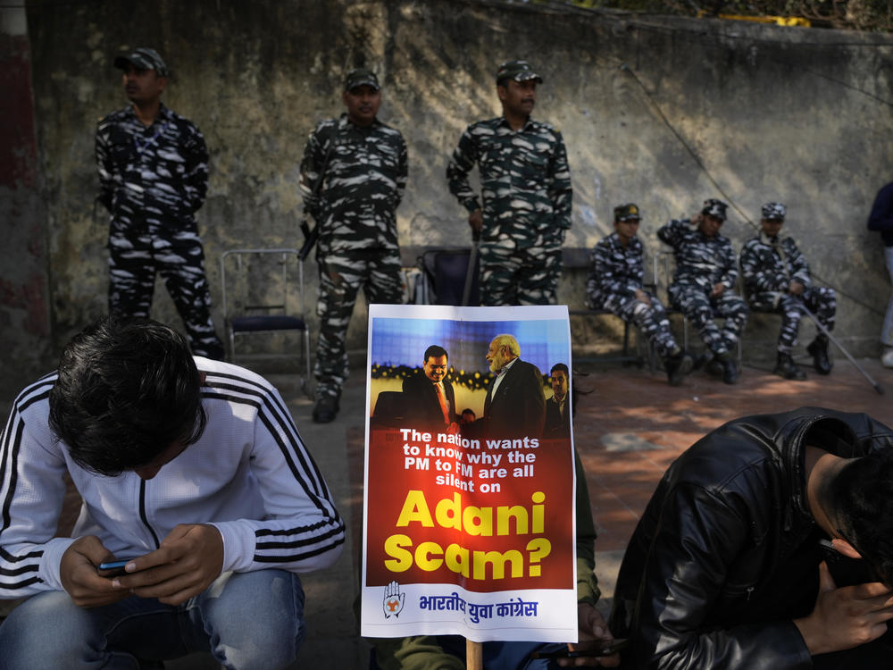 Members of opposition Congress party, demanding an investigation into allegations of fraud and stock manipulation by India's Adani Group, display a placard with images of Indian businessman Gautam Adani and Indian Prime Minister Narendra Modi during a protest in New Delhi, Feb.6.