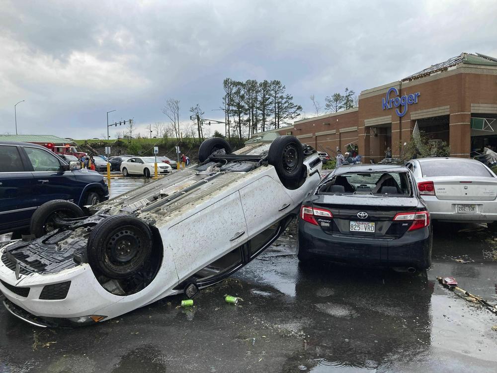 A car is upturned in a Kroger parking lot after severe storm swept through Little Rock, Ark., on Friday.