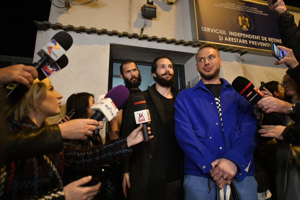 Andrew Tate, left, and his brother Tristan leave a police detention facility in Bucharest, Romania, after his release from prison on Friday.