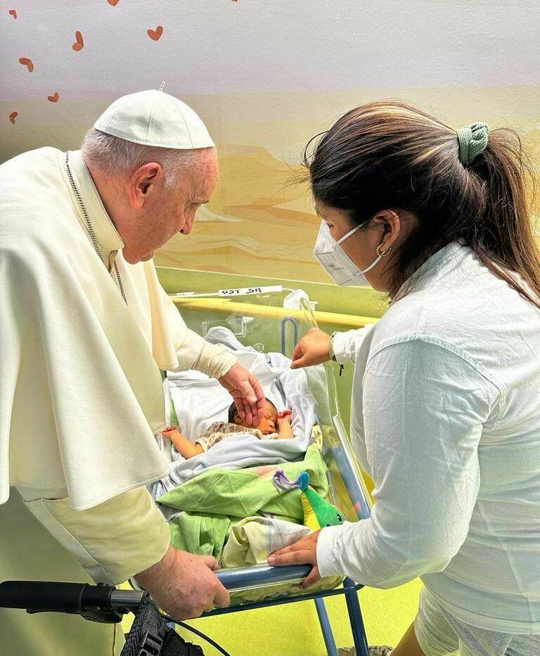 Pope Francis baptizes a baby at Rome's Gemelli Hospital, where the pope is being treated, on Friday.