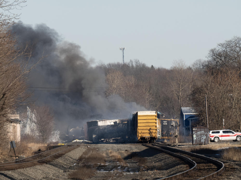 Smoke rises from a derailed cargo train in East Palestine, Ohio, on February 4, 2023.