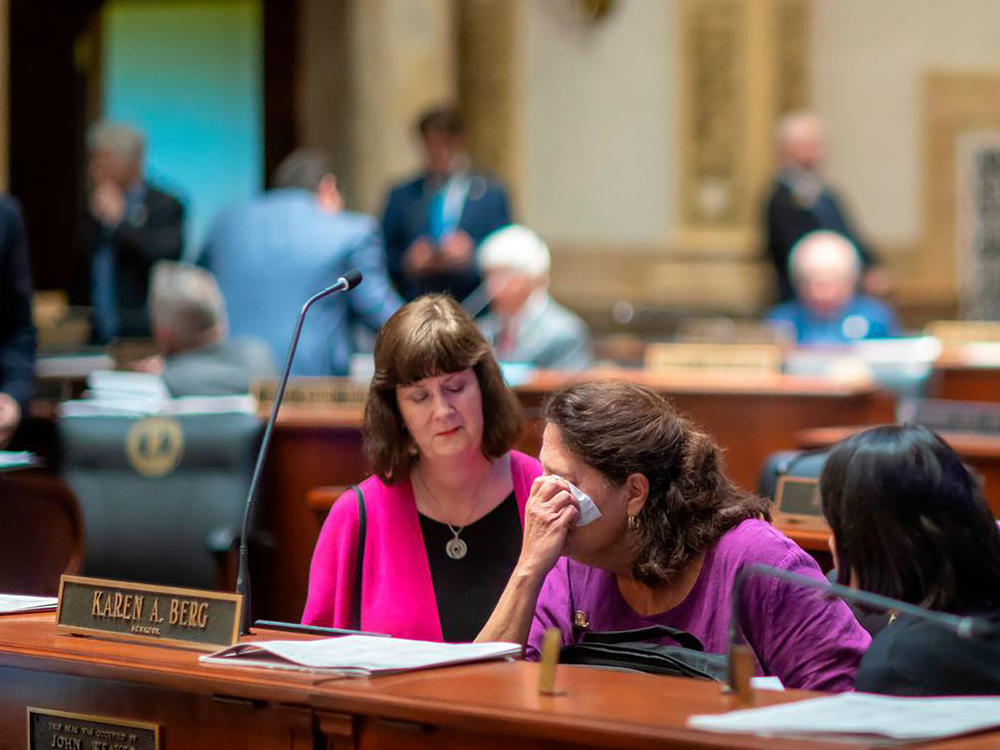 Kentucky state Sen. Karen Berg, who lost her transgender son to suicide in 2022, is consoled by former state legislator Patti Minter, left, and Rep. Tina Bojanowski after SB 150 passed the Senate on Feb. 16, 2023, in Frankfort, Ky.