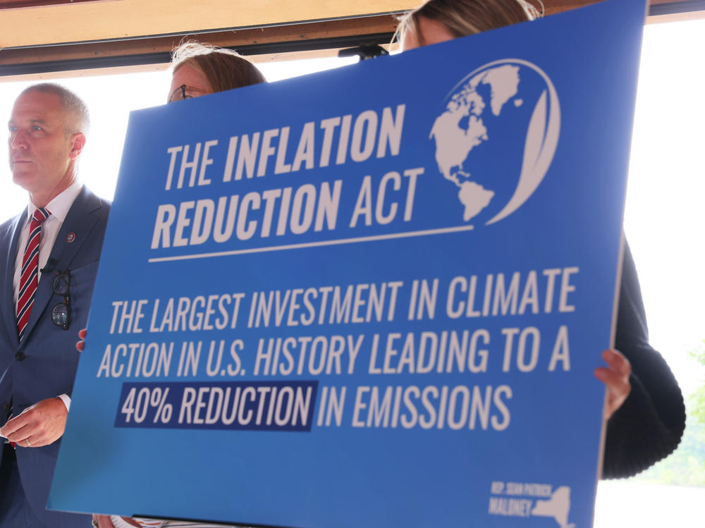 A sign touting the Inflation Reduction Act is seen at Glynwood Boat House in Cold Spring, N.Y., on Aug. 17, 2022.