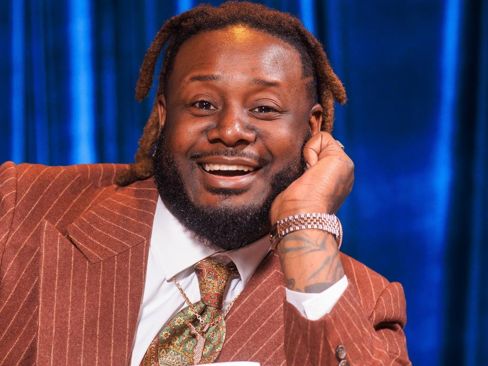 The rapper T-Pain poses with his 2023 album, <em>On Top of the Covers</em>.