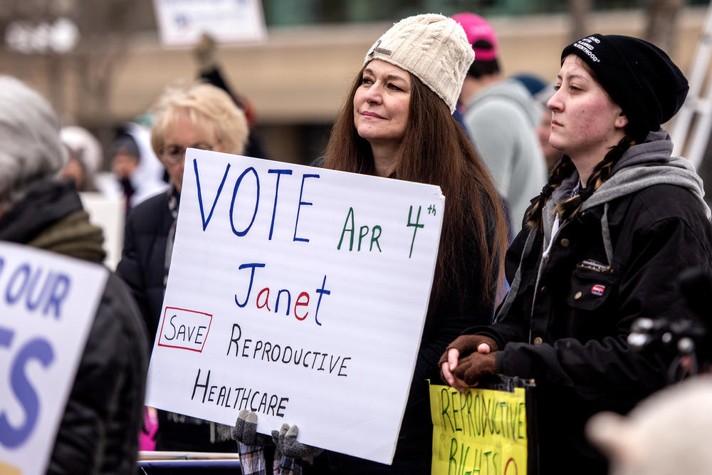 Melissa Johnson holds a sign in support of Wisconsin state Supreme Court candidate Judge Janet Protasiewicz during a rally on March 11 in Appleton, Wis.