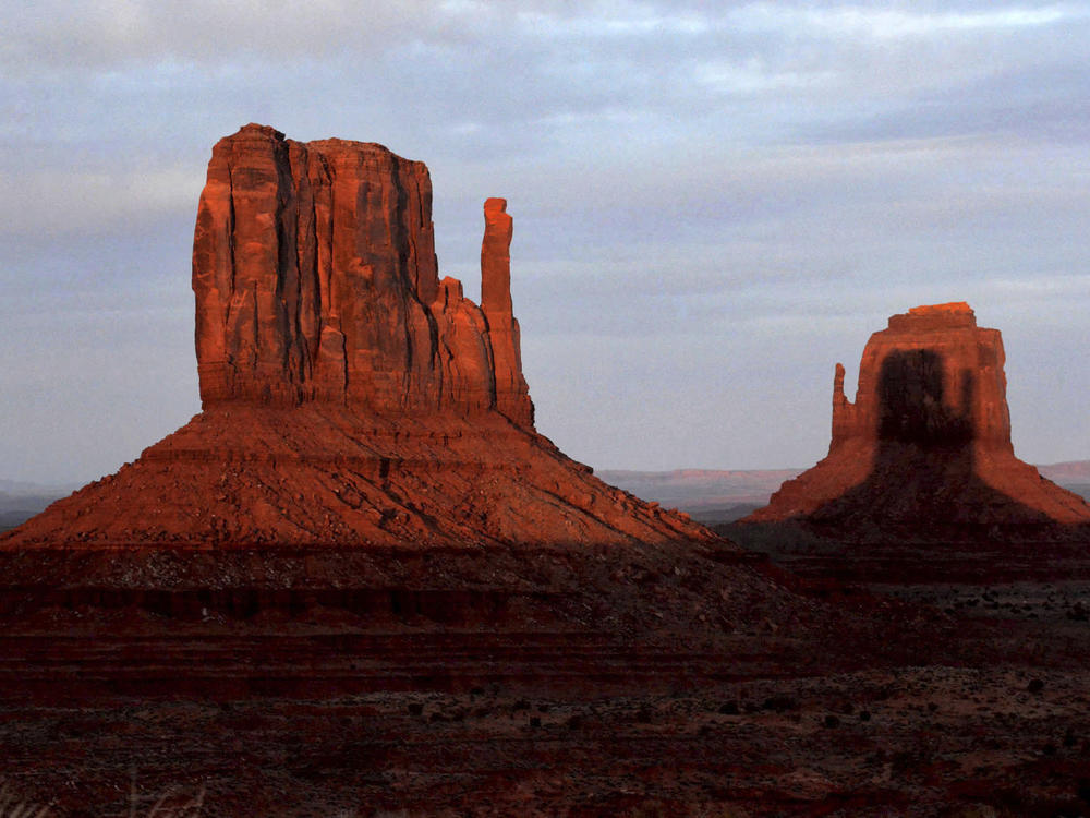 A sunset spectacle featuring two mitten-shaped rock formations crosses Monument Valley Tribal Park on Wednesday.