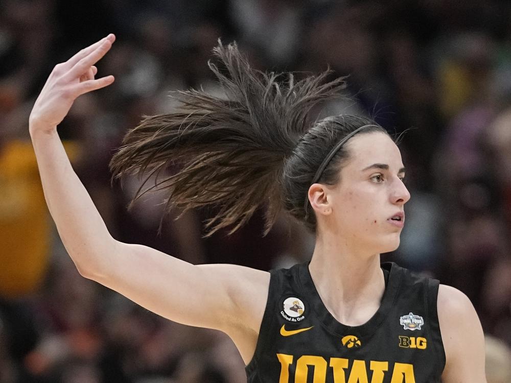 Iowa's Caitlin Clark reacts after a 3-pointer during the second half of an NCAA Women's Final Four semifinals basketball game against South Carolina on Friday in Dallas.