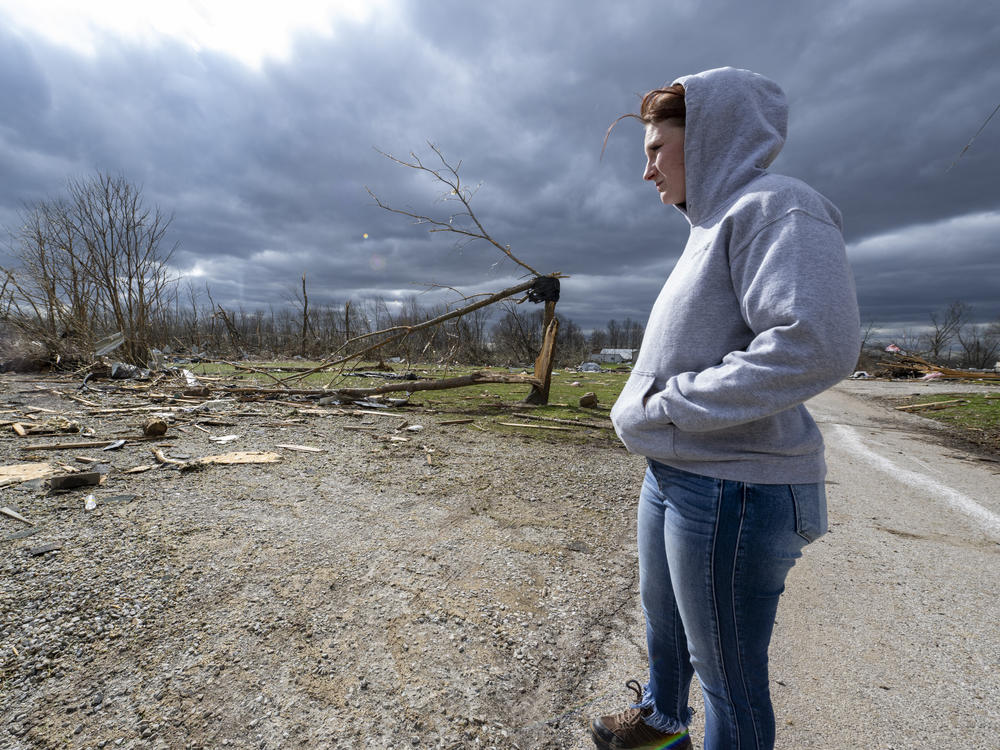 Jaycee Ahlefeld surveys the damage left after a late-night tornado devastated the area in Sullivan, Ind. on Saturday. Ahlefeld's son attended a day care that had been on what is now an empty lot. Multiple deaths were reported in the area following the storm.