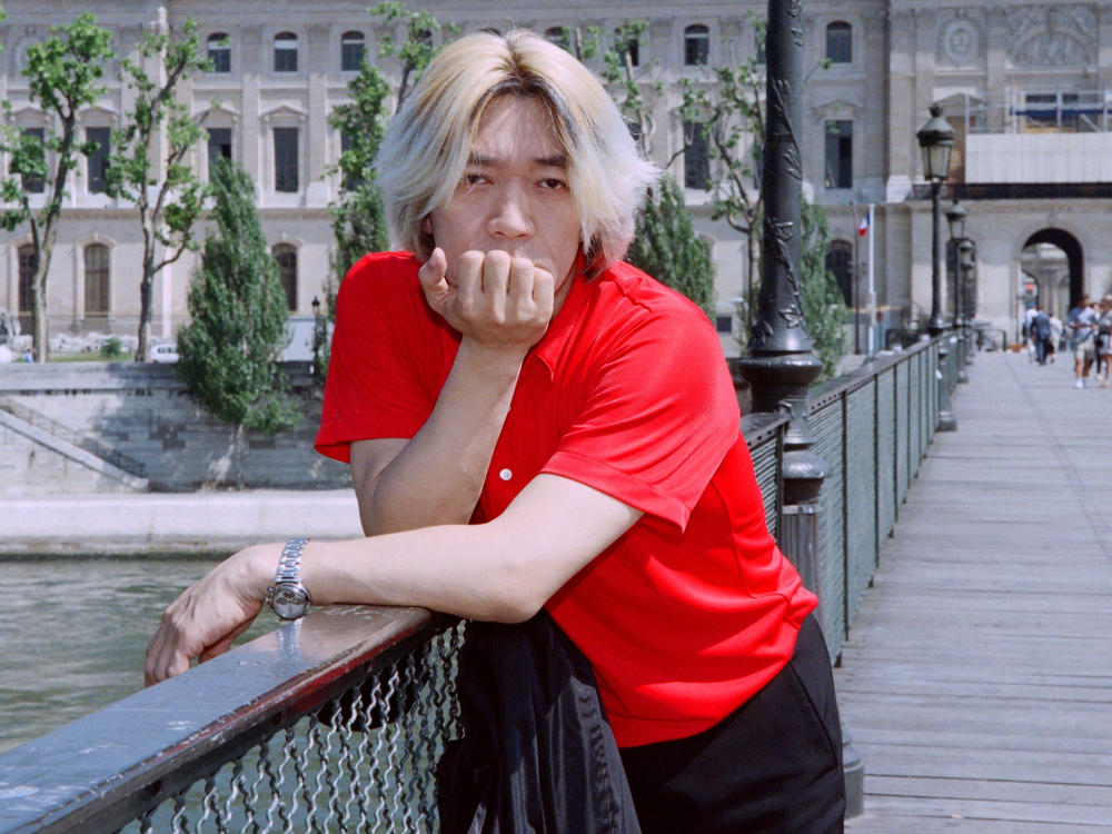 Ryuichi Sakamoto posing for a portrait in Paris in 1996.