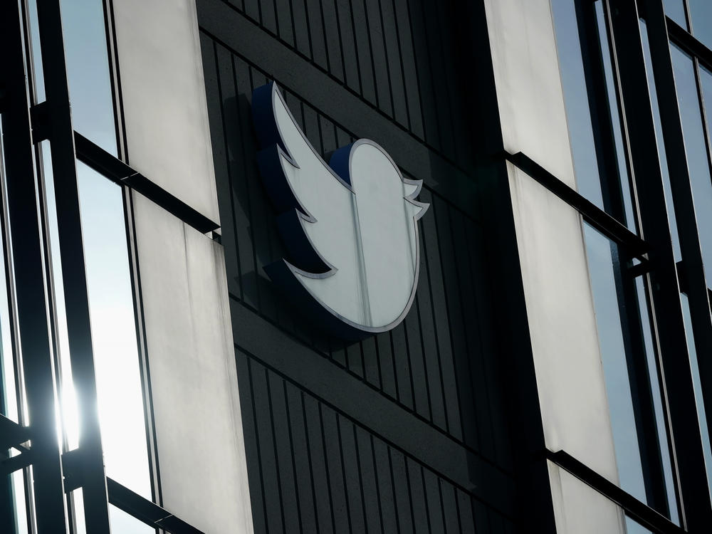 A Twitter logo hangs outside the company's offices in San Francisco, on Dec. 19, 2022.