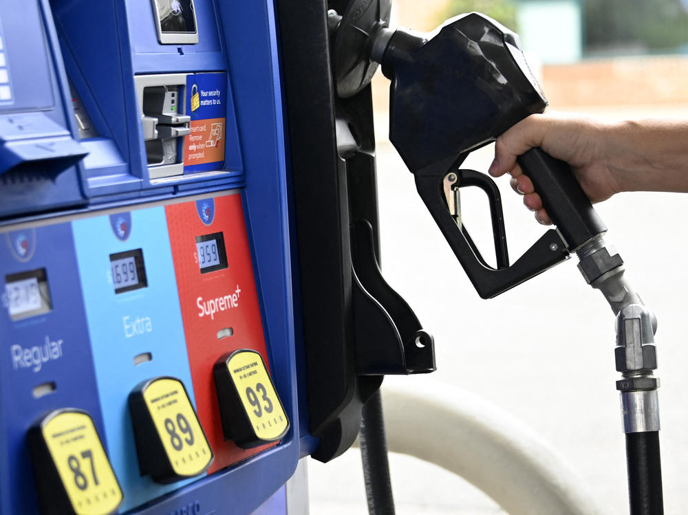 A person goes to the pump at a gas station in Arlington, Va., on July 29, 2022. Gas prices have come down significantly since peaking last year but they could rise again after Saudi Arabia and other countries said they would collectively cut oil production by more than one million barrels.