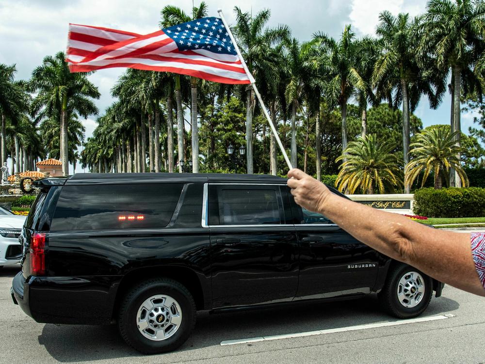 Former President Donald Trump sits in the rear of his limousine as he departs Trump International Golf Club in West Palm Beach, Florida, on Sunday.
