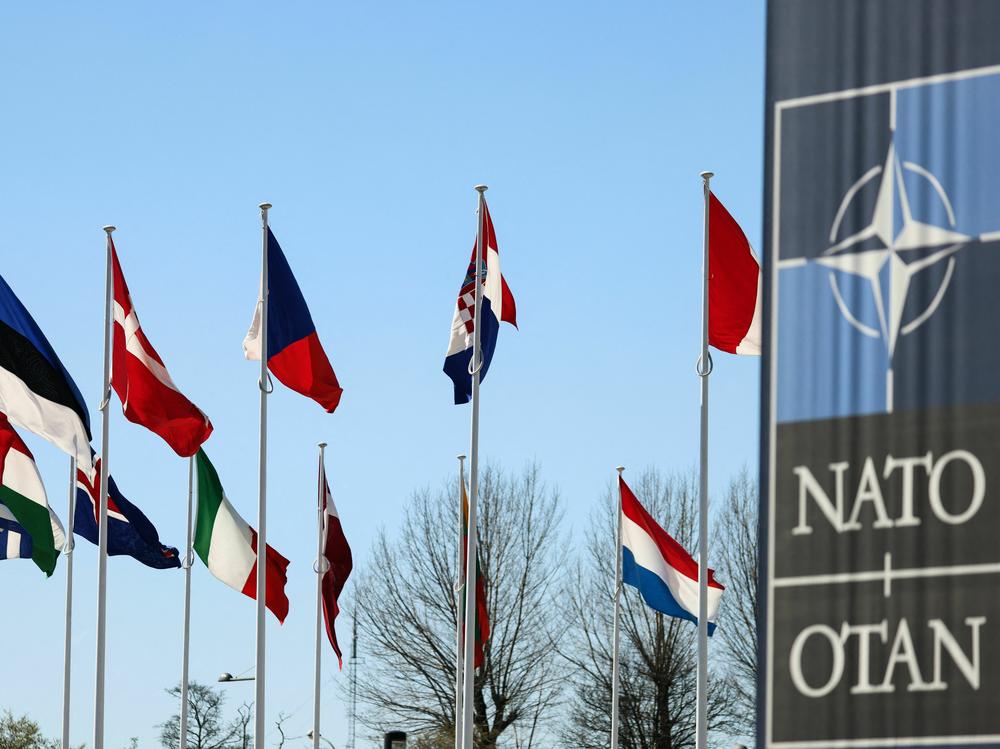 The national flags of countries in NATO fly outside the organization headquarters in Brussels on Monday. Finland's flag will be added to the group.