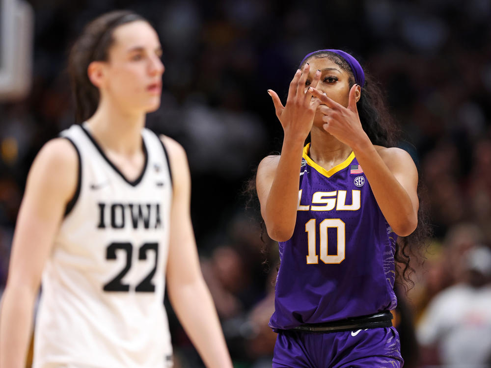 Angel Reese of the LSU Tigers gestures toward Caitlin Clark of the Iowa Hawkeyes toward the end of the NCAA Women's Basketball Tournament championship game in Dallas on Sunday.