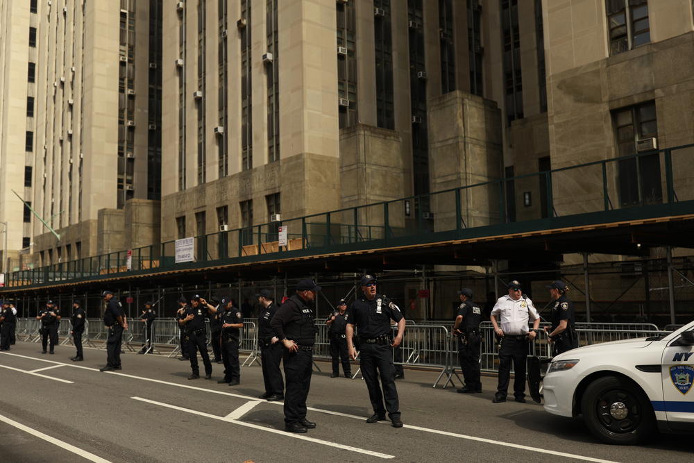 Members of law enforcement station themselves outside of the entrance of Manhattan Criminal Courts Building as anti-Trump protesters and supporters of the former president eagerly await a glimpse of Donald J. Trump in Manhattan, New York, U.S., on Tuesday, April 3, 2023.