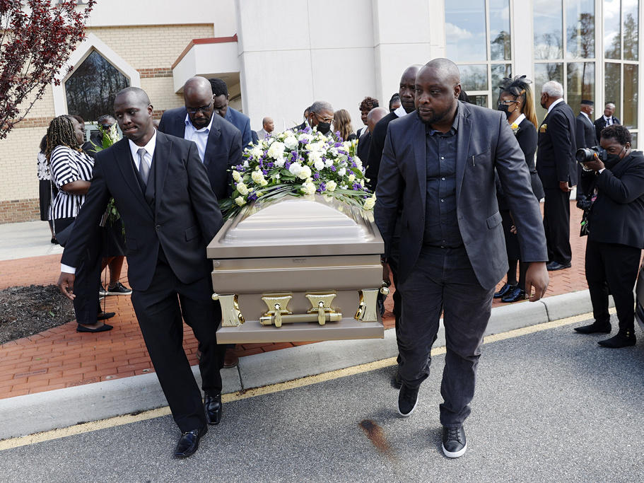 The casket of Irvo Otieno is carried out of First Baptist Church of South Richmond on March 29 after the celebration of life for Irvo Otieno in North Chesterfield, Va. The 28-year-old Black man died after he was pinned to the floor by seven sheriff's deputies and several others while he was being admitted to a mental hospital.