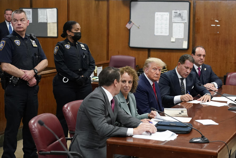 Former President Donald Trump sits at the defense table with his legal team in a Manhattan court.