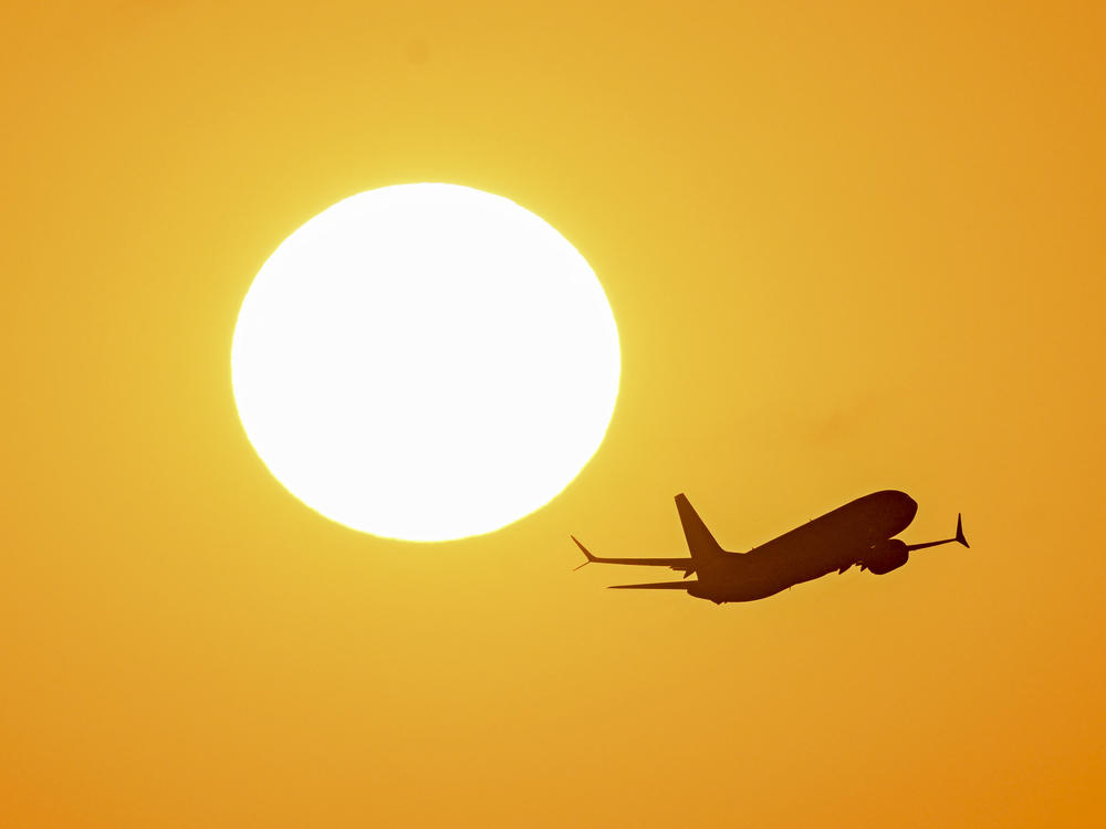 An airplane flies at sunrise over Buenos Aires, Argentina, on March 9.