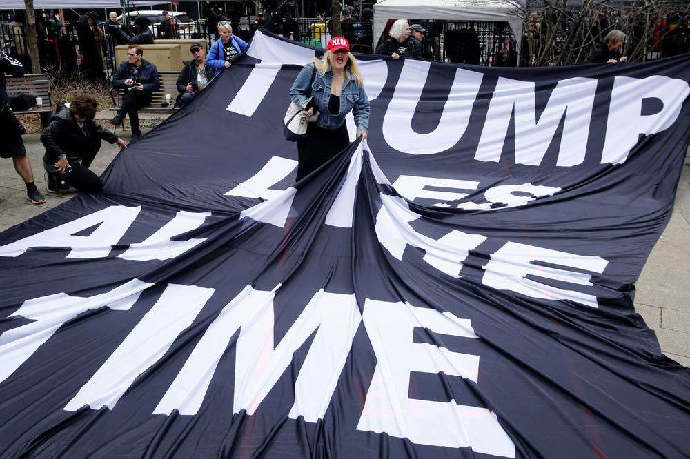 A supporter of former President Donald Trump argues with opponents outside the Manhattan District Attorney's office in New York City.