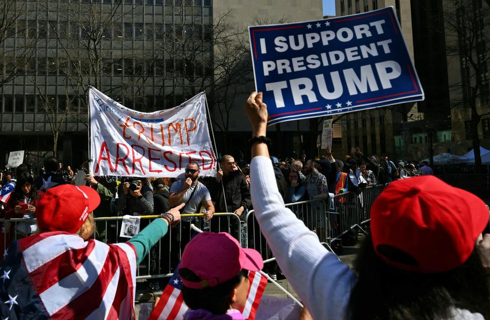 Supporters of former President Donald Trump argue with opponents outside the Manhattan District Attorney's office in New York City.