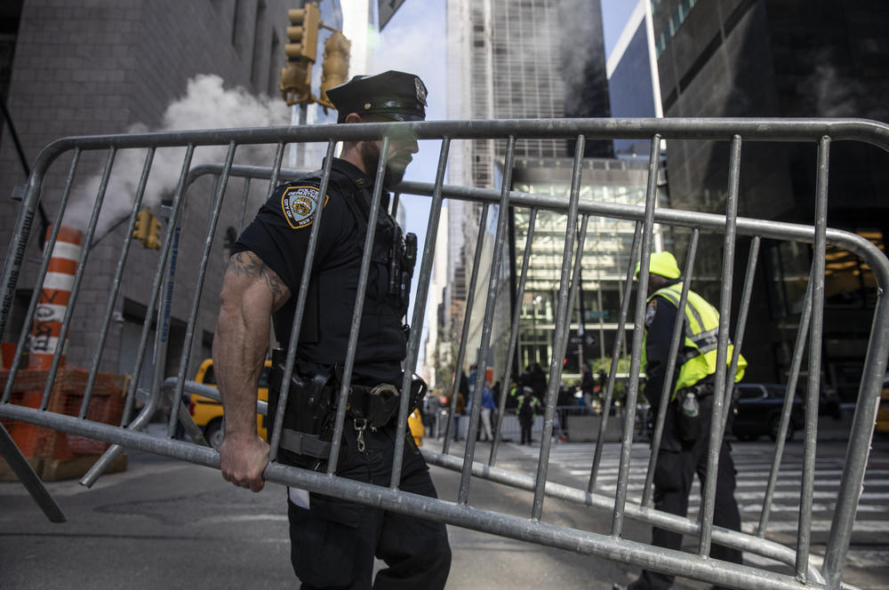 A New York City police officer sets up barricades near Trump Tower.